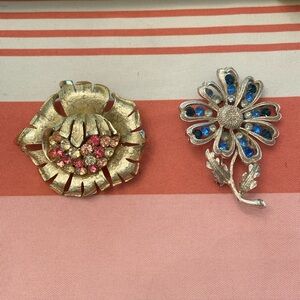 2 vintage floral rhinestone pins signed Coro. Goldtone w pink; silvertone w blue